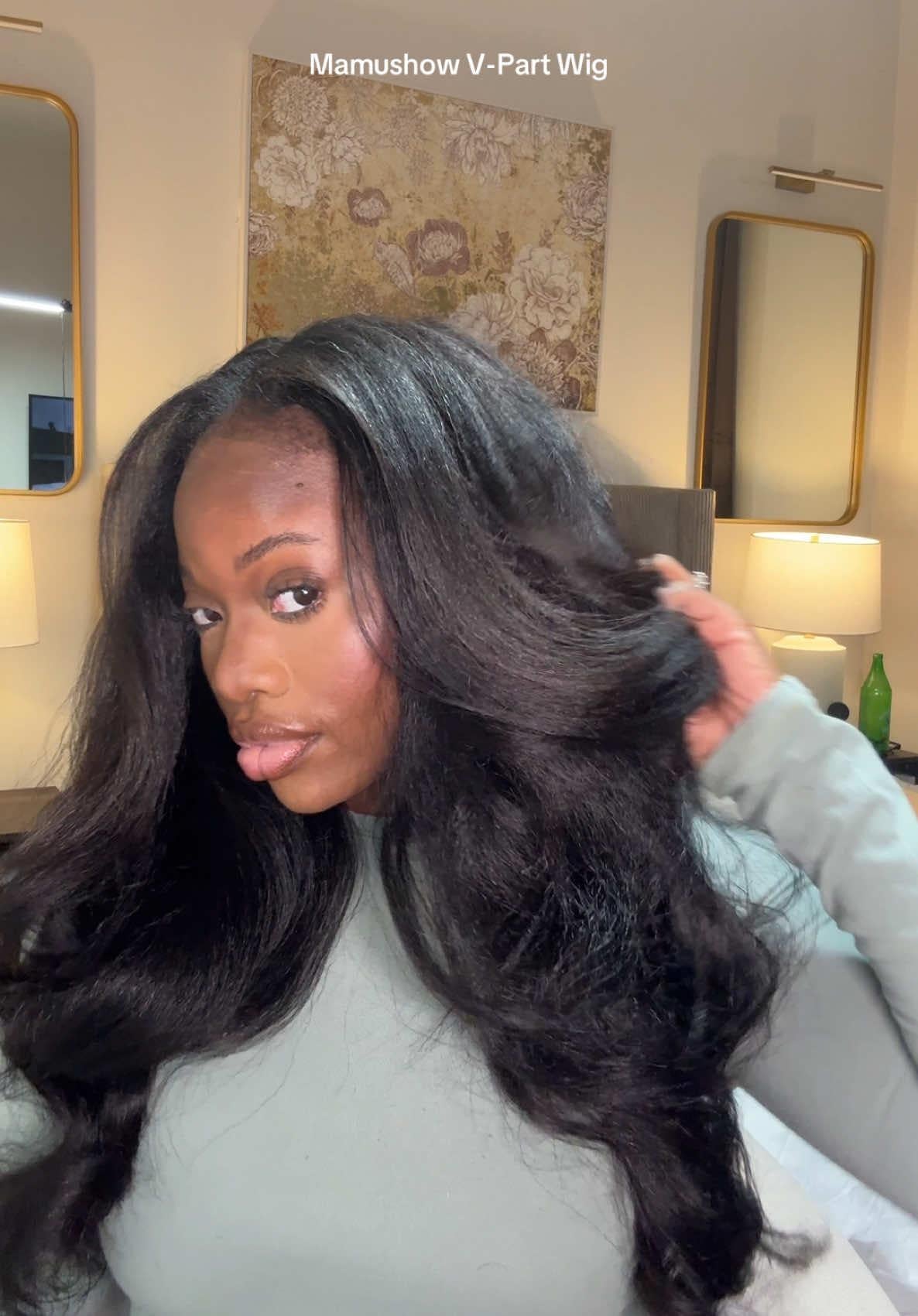 Wearer checking the finished V-part wig in a mirror