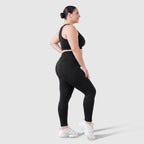 Woman wearing Sculpt 3D™ anti-cellulite leggings in black, side view, showing the 3D sculpt lines