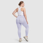 Woman wearing Sculpt 3D™ anti-cellulite leggings in light blue, back view, lifted, contoured rear