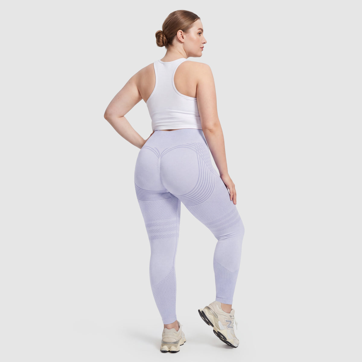 Woman wearing Sculpt 3D™ anti-cellulite leggings in light blue, back view, lifted, contoured rear