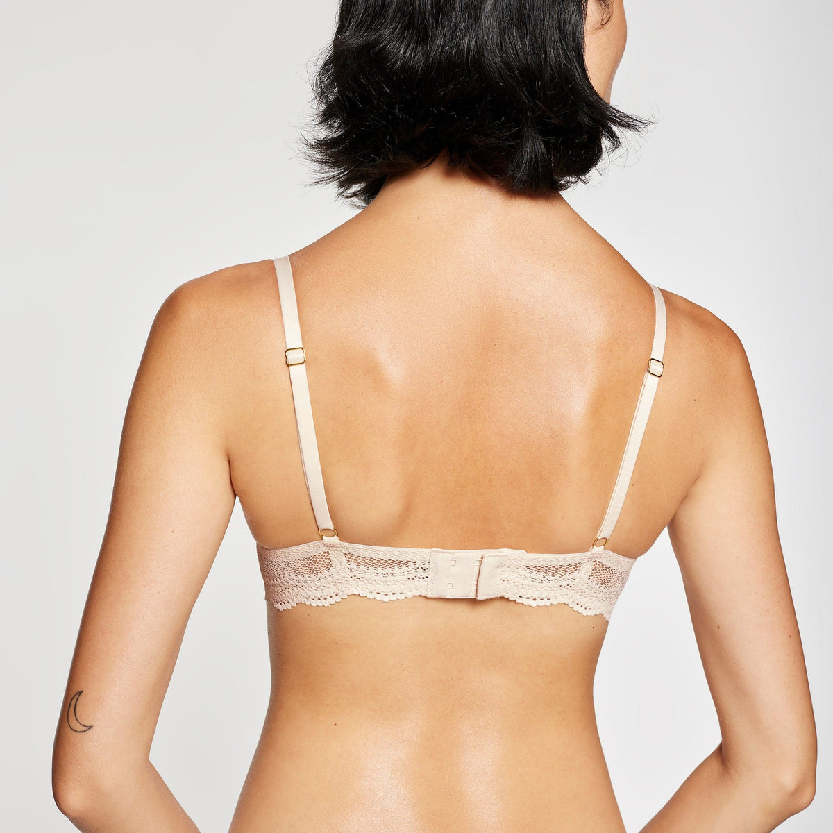 Model wearing the Signature All You Bra in Sand, back view with clasp detail