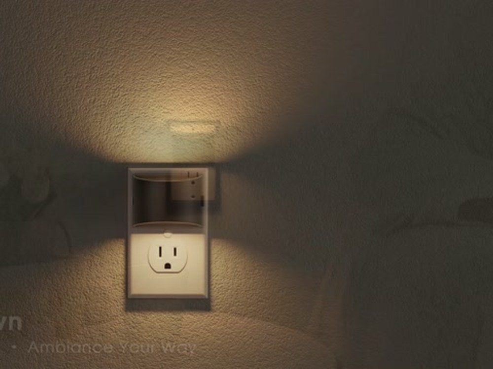 Warm white square night light with dusk-to-dawn glow on a wall