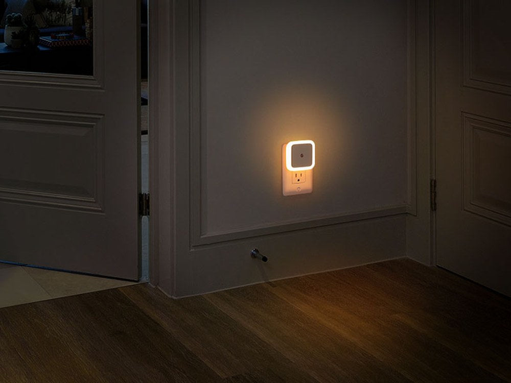 Warm white square night light on a hallway wall