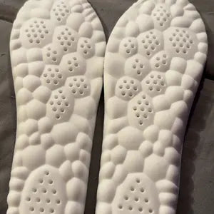 White cloud-cell underside of a pair of insoles